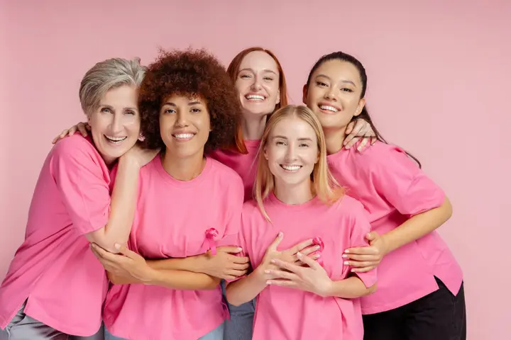 A group of women wearing pink T-shirts to support breast cancer awareness