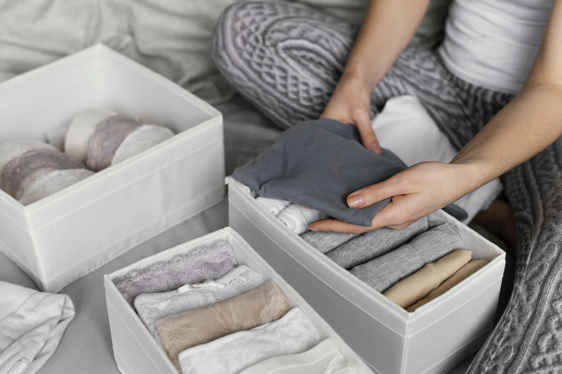 Folded bras sorted in an open drawer ready to be donated