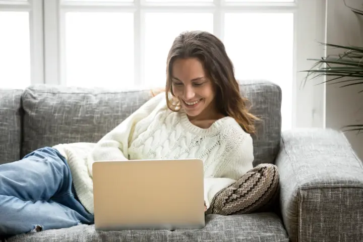 Person using a laptop at home to make an online donation to a UK charity